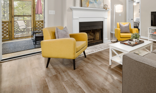A fully furnished living room with wood flooring.